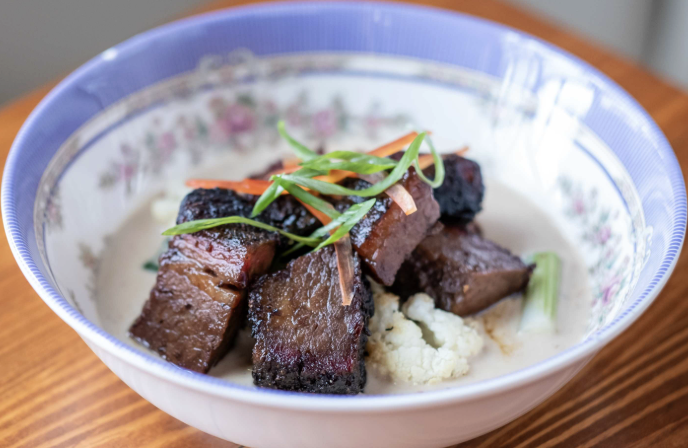 Eem signature dishes White Curry with Brisket Burnt Ends, Smoked Pork Krapao, Chopped BBQ Fried Rice, Colada-Scope Cocktail